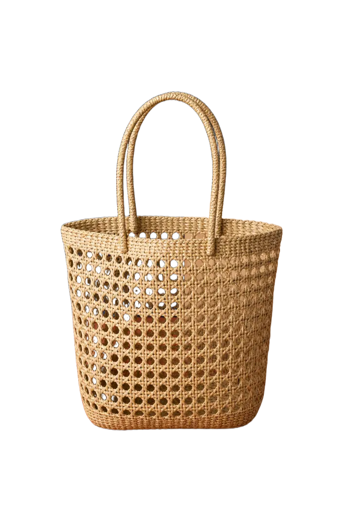 Woven straw tote bag isolated on a white background with the lattice openings preserved.